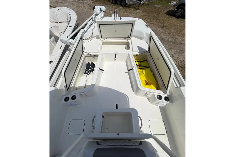 Slide: The Image of 2019 World Cat 230 CC boat deck with open storage compartments and equipment. - 24