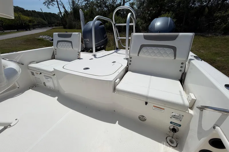 Slide: The Image of 2019 World Cat 230 CC boat interior with seating and dual engines. - 27