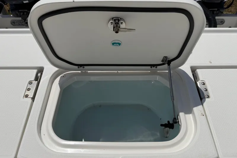 Slide: The Image of Open storage compartment on 2019 World Cat 230 CC boat, showcasing interior space. - 30