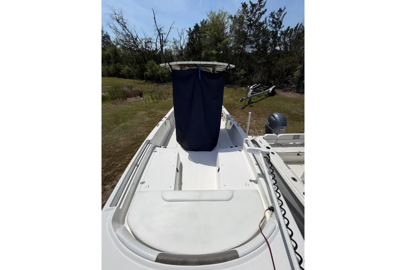 Slide: The Image of 2019 World Cat 230 CC boat on land, surrounded by trees. - 32