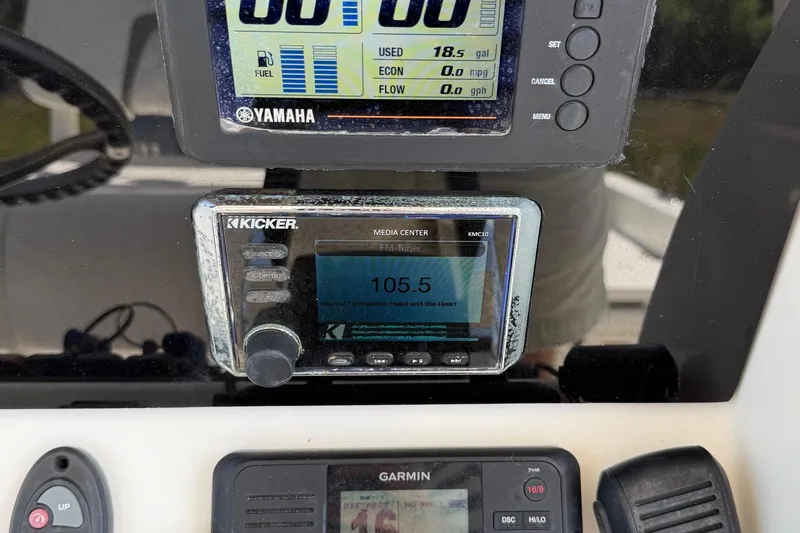 Slide: The Image of Control panel of a 2019 World Cat 230 CC boat with Yamaha and Kicker displays. - 37
