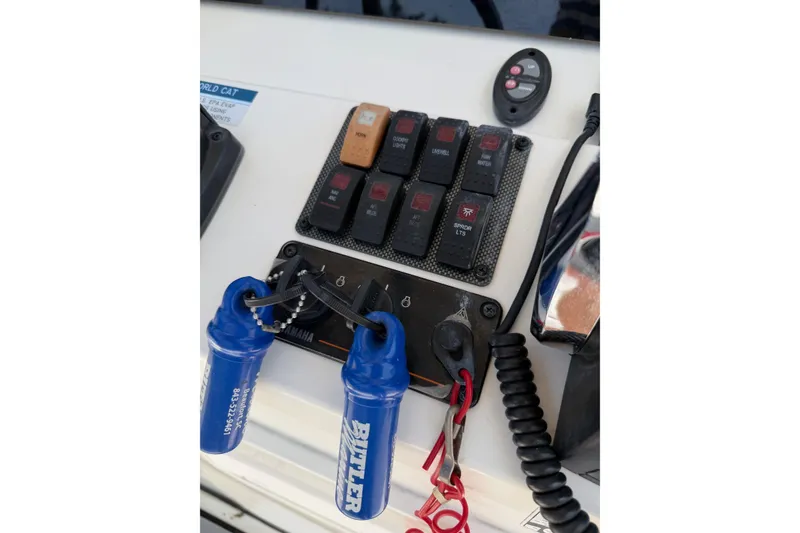 Slide: The Image of Control panel of a 2019 World Cat 230 CC boat with switches and keys. - 38