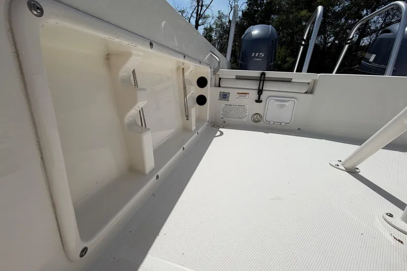 Slide: The Image of 2019 World Cat 230 CC boat deck with storage compartments and Yamaha outboard engines. - 40