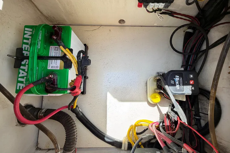 Slide: The Image of Battery compartment of a 2019 World Cat 230 CC boat with wiring and components. - 44