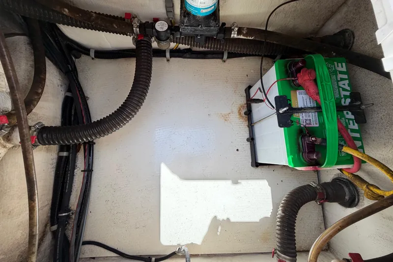 Slide: The Image of Battery compartment of 2019 World Cat 230 CC boat with wiring and hoses. - 45