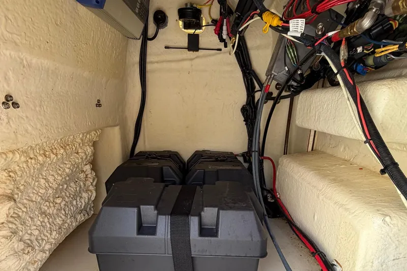 Slide: The Image of Battery compartment of 2019 World Cat 230 CC boat with wiring and components. - 48