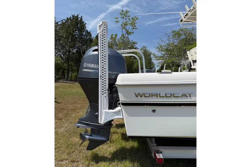 Slide: The Image of 2019 World Cat 230 CC boat with Yamaha outboard motor, parked on grass. - 5