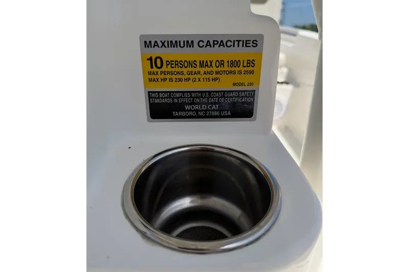 Slide: The Image of 2019 World Cat 230 CC boat capacity label, 10 persons or 1800 lbs, with cup holder. - 52