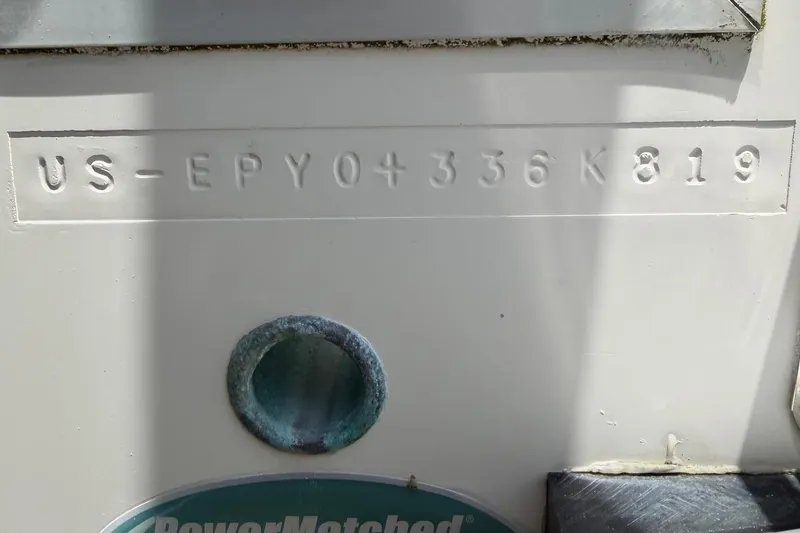 Slide: The Image of 2019 World Cat 230 CC boat hull identification number (HIN) embossed on white surface. - 54