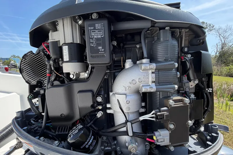 Slide: The Image of Close-up of a 2019 World Cat 230 CC boat engine, showcasing intricate mechanical components. - 59
