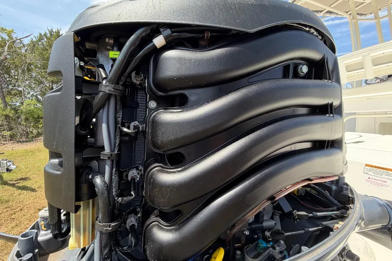 Slide: The Image of Close-up of a 2019 World Cat 230 CC boat engine, showcasing intricate components. - 60