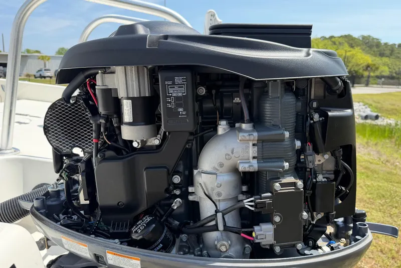 Slide: The Image of Close-up of a 2019 World Cat 230 CC boat engine, showcasing intricate mechanical details. - 62