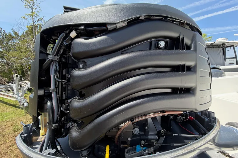 Slide: The Image of Close-up of a 2019 World Cat 230 CC boat engine, showcasing intricate mechanical details. - 63