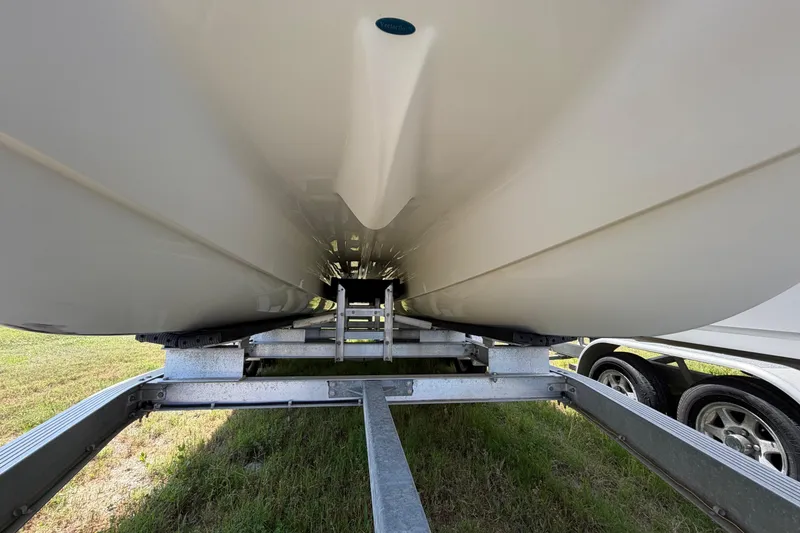 Slide: The Image of Underneath view of a 2019 World Cat 230 CC boat on a trailer. - 68