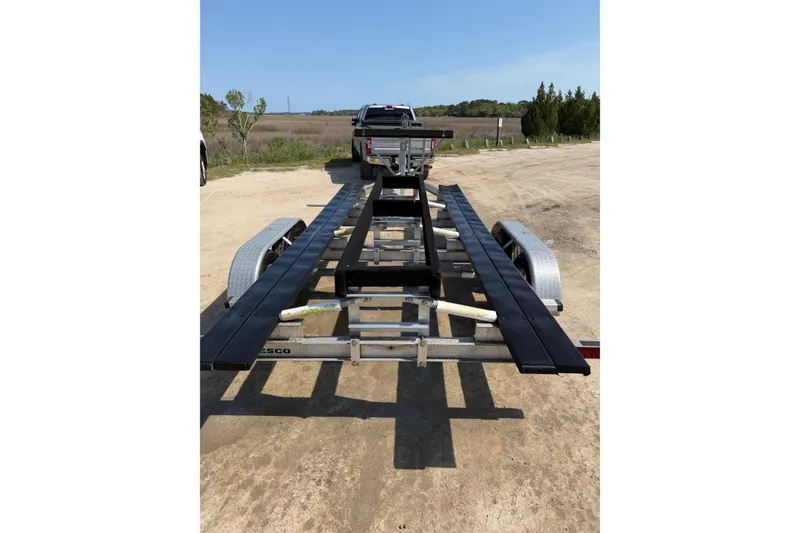 Slide: The Image of Trailer for 2019 World Cat 230 CC boat on a dirt road. - 73