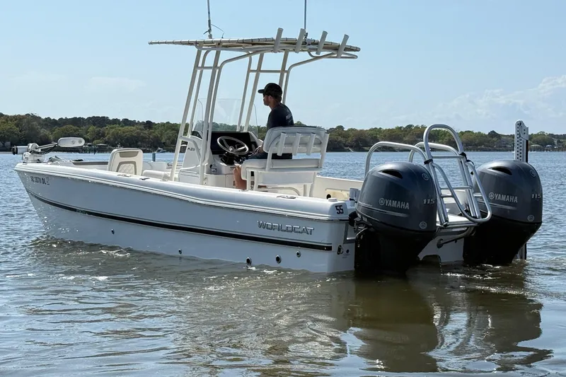 Slide: The Image of 2019 World Cat 230 CC boat with dual Yamaha engines on calm water. - 9