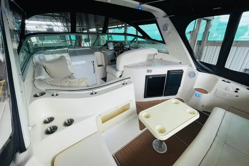 Slide: The Image of 2002 Rinker Fiesta Vee 342 boat interior with seating, table, and helm. - 13