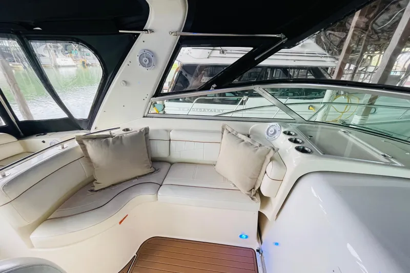 Slide: The Image of Interior of 2002 Rinker Fiesta Vee 342 yacht with cushioned seating and windows. - 14