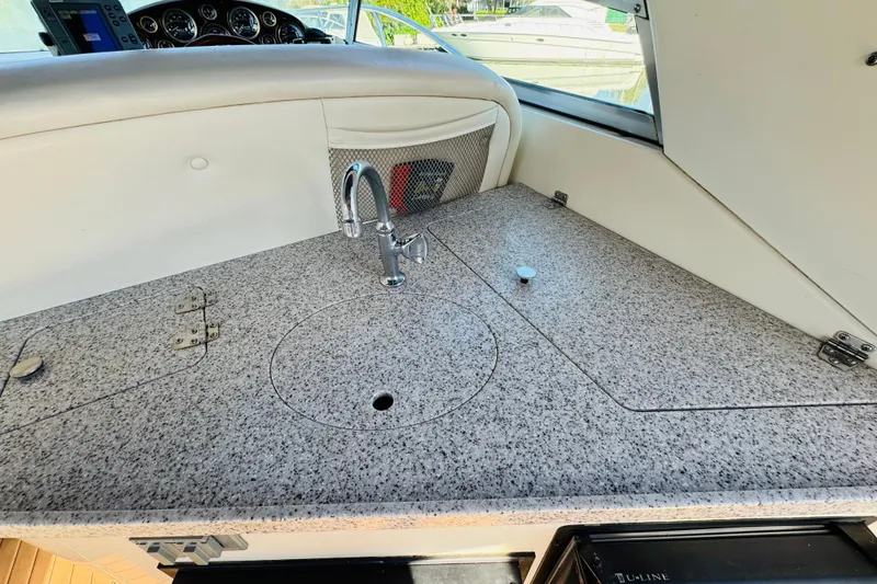 Slide: The Image of 2002 Rinker Fiesta Vee 342 boat interior with granite countertop and sink. - 21