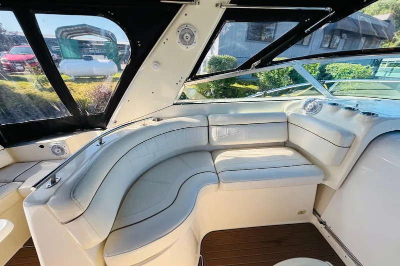 Slide: The Image of 2002 Rinker Fiesta Vee 342 boat interior with white leather seating and wood flooring. - 24