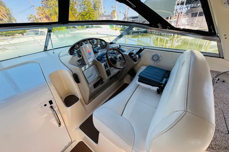 Slide: The Image of 2002 Rinker Fiesta Vee 342 boat cockpit with steering wheel and navigation equipment. - 25