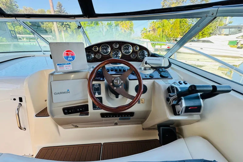 Slide: The Image of 2002 Rinker Fiesta Vee 342 boat cockpit with Garmin navigation and wooden steering wheel. - 26