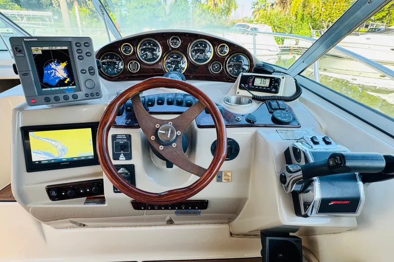 Slide: The Image of 2002 Rinker Fiesta Vee 342 helm with navigation equipment and steering wheel. - 27