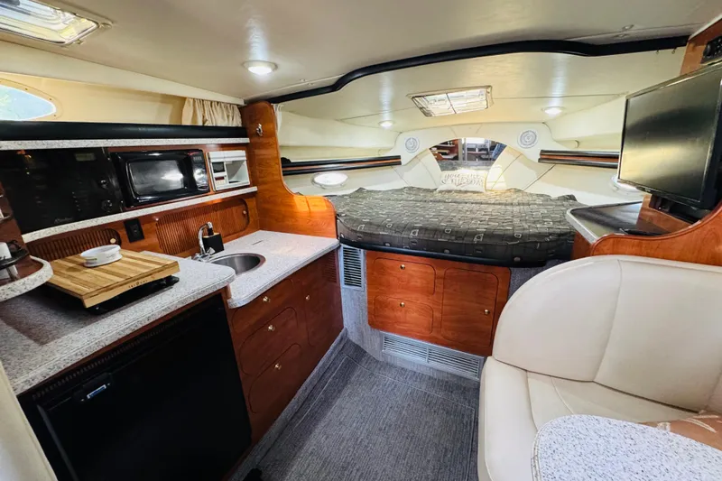 Slide: The Image of Interior of 2002 Rinker Fiesta Vee 342 yacht with kitchenette and cozy sleeping area. - 37