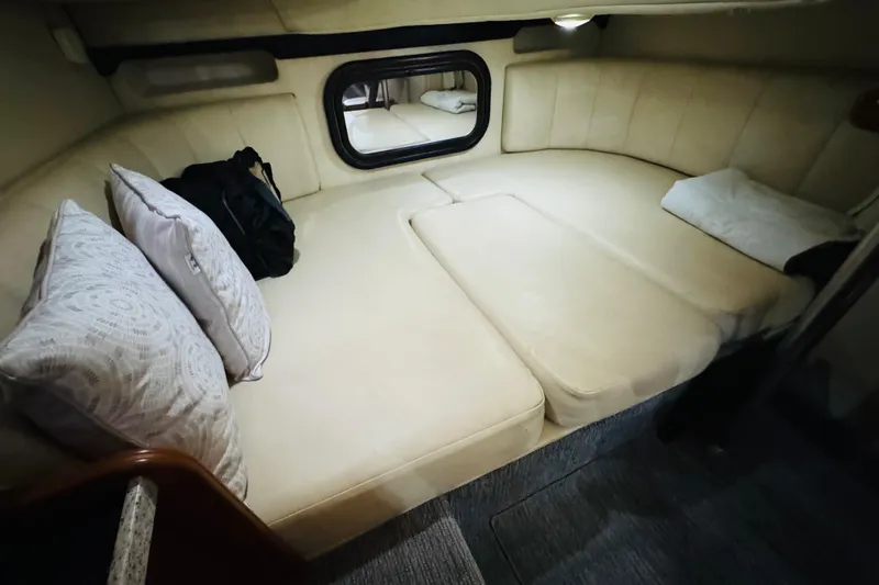 Slide: The Image of Interior cabin of 2002 Rinker Fiesta Vee 342 with beige cushions and pillows. - 39