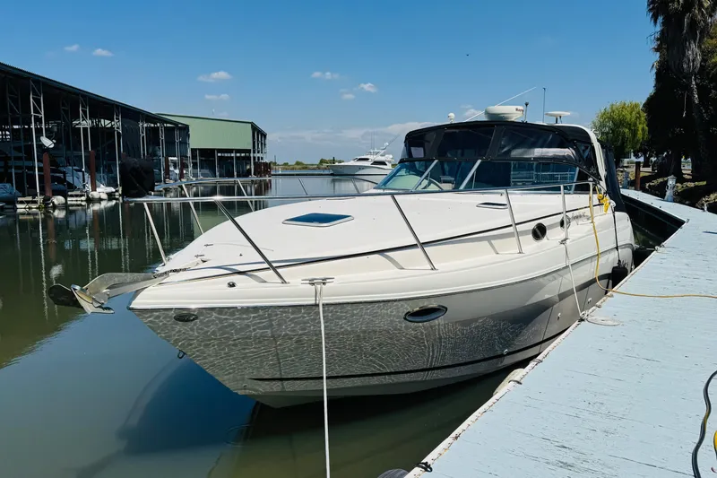 Slide: The Image of 2002 Rinker Fiesta Vee 342 docked at marina under clear blue sky. - 4