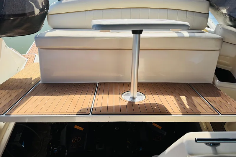 Slide: The Image of 2002 Rinker Fiesta Vee 342 boat interior with wooden deck and seating area. - 50