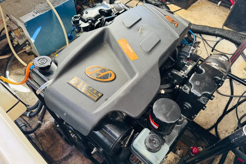 Slide: The Image of Engine compartment of a 2002 Rinker Fiesta Vee 342 boat, featuring a V8 engine. - 53