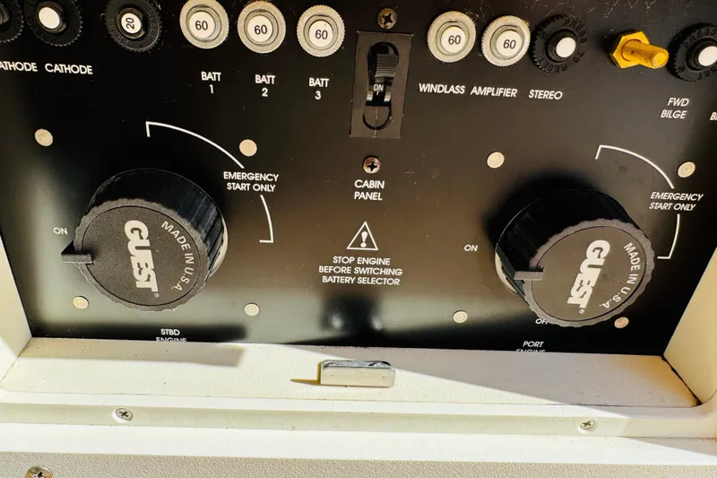 Slide: The Image of Control panel of a 2002 Rinker Fiesta Vee 342 boat with battery selectors and switches. - 56