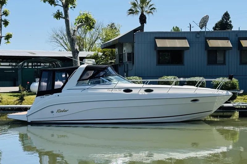 Slide: The Image of 2002 Rinker Fiesta Vee 342 boat docked by a building on a sunny day. - 7