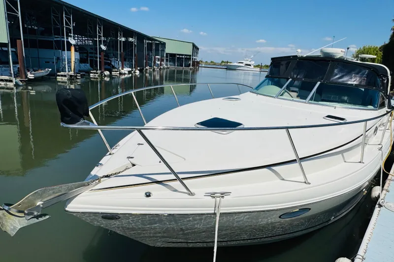 Slide: The Image of 2002 Rinker Fiesta Vee 342 docked at marina under clear blue sky. - 8