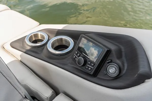 Slide: The Image of 2023 Bennington QX 25 QXSBA boat console with cup holders and control panel. - 11