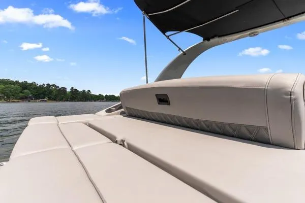 Slide: The Image of 2023 Bennington QX 25 QXSBA boat interior with beige seating on a sunny day. - 14