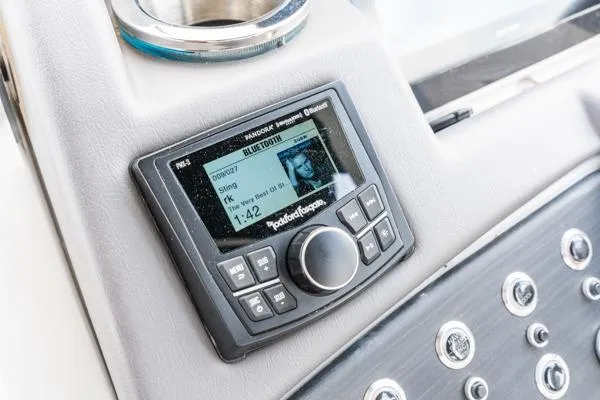 Slide: The Image of 2023 Bennington QX 25 QXSBA boat dashboard with Rockford Fosgate audio system display. - 17