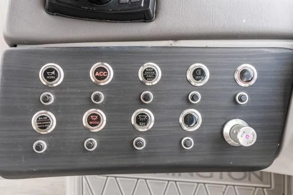 Slide: The Image of Control panel of 2023 Bennington QX 25 QXSBA boat with labeled buttons and switches. - 18