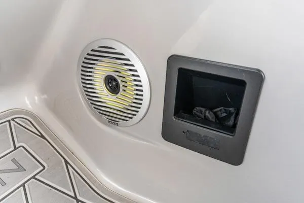 Slide: The Image of Speaker and storage compartment on 2023 Bennington QX 25 QXSBA boat interior. - 19