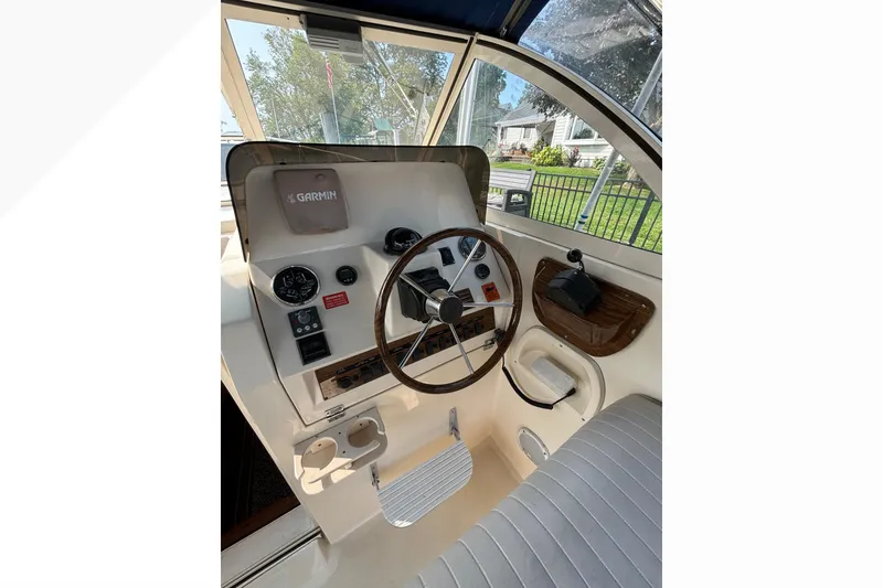 Slide: The Image of 2005 Mainship Pilot 30-II Sedan helm with Garmin navigation, steering wheel, and gauges. - 16