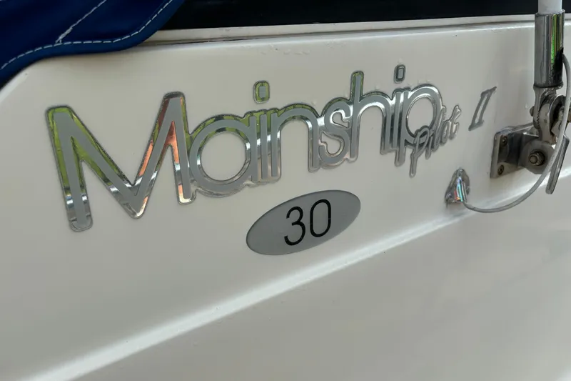 Slide: The Image of 2005 Mainship Pilot 30-II Sedan logo on boat exterior. - 19