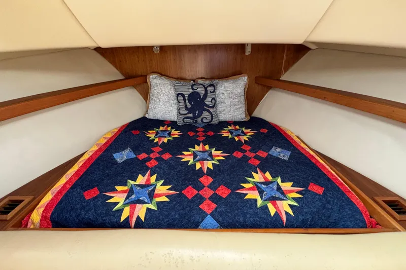 Slide: The Image of Cozy cabin interior of 2005 Mainship Pilot 30-II Sedan with colorful quilt and octopus pillow. - 22