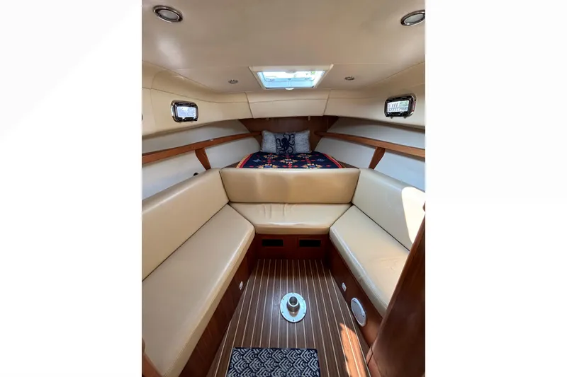 Slide: The Image of Interior of 2005 Mainship Pilot 30-II Sedan with beige seating and wooden flooring. - 23