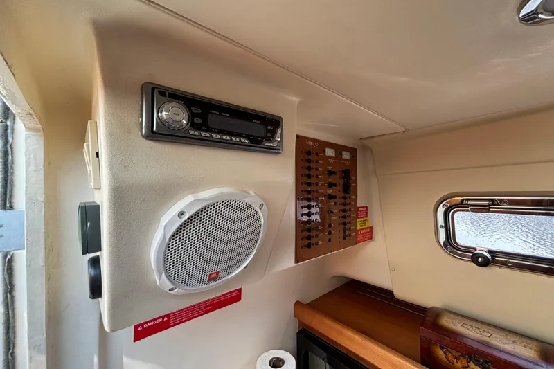 Slide: The Image of Interior of 2005 Mainship Pilot 30-II Sedan with stereo, speaker, and control panel. - 28
