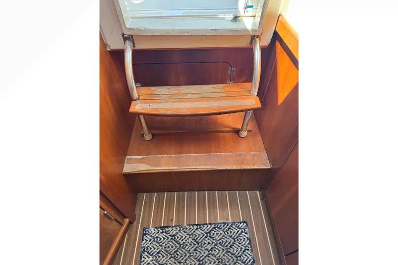 Slide: The Image of Wooden steps and patterned rug inside 2005 Mainship Pilot 30-II Sedan boat. - 29