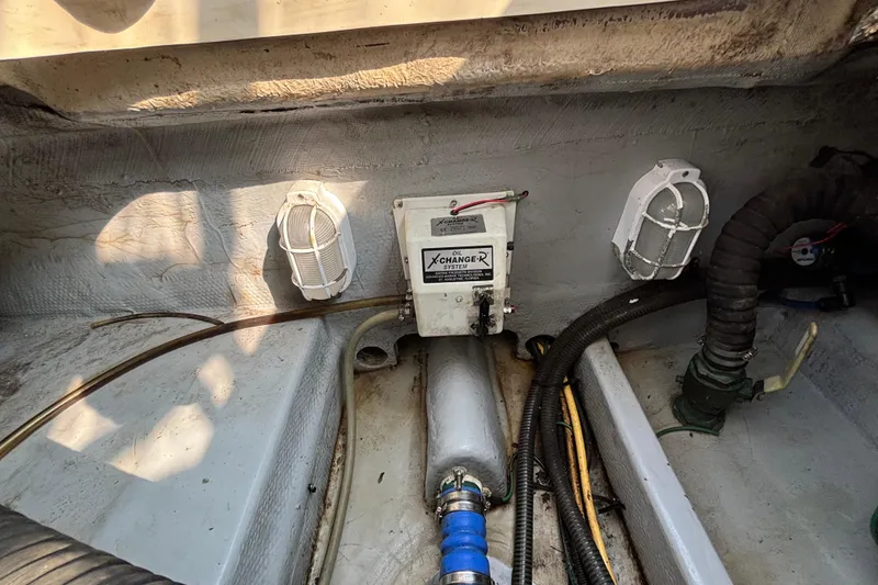 Slide: The Image of Engine compartment of 2005 Mainship Pilot 30-II Sedan with oil change system and wiring. - 33