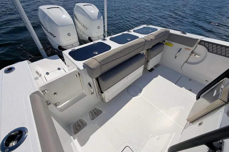 Slide: The Image of 2021 Wellcraft 302 Fisherman boat interior with dual Mercury engines on water. - 10