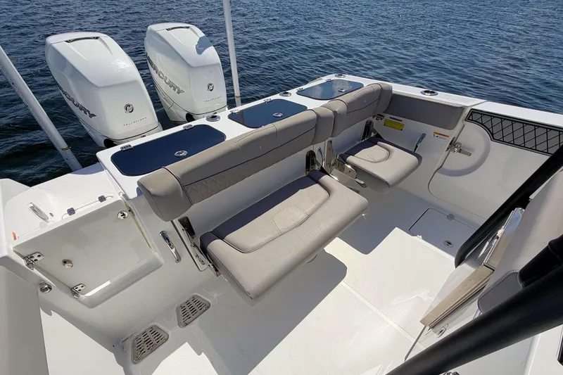 Slide: The Image of 2021 Wellcraft 302 Fisherman boat interior with seating and twin Mercury engines. - 11