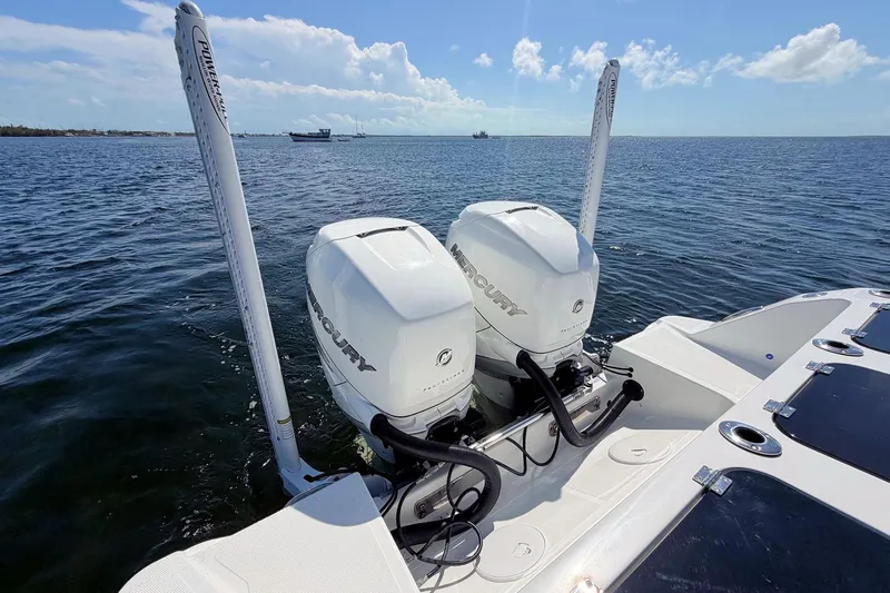 Slide: The Image of 2021 Wellcraft 302 Fisherman with twin Mercury outboard engines on open water. - 12